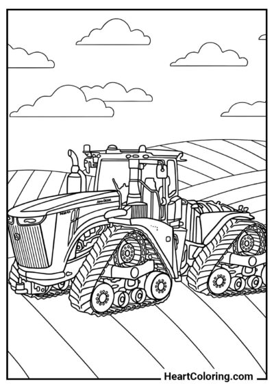 Kolorowanka PDF: Olbrzymi traktor gąsienicowy na polu — do pobrania